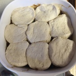 uncooked biscuit dough on top of ground beef mixture